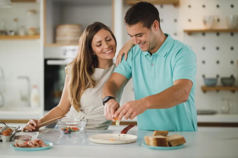 A couple cooking a fresh meal together at home